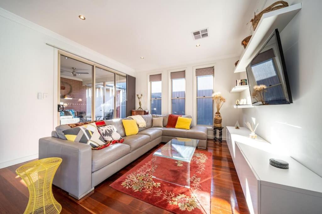 a living room with a couch and a table at The Arlington - Easy Stay near Entertainment & CBD in Bowden