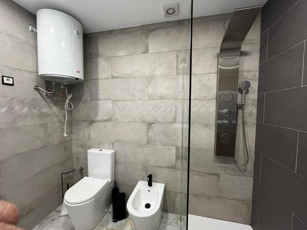 a bathroom with a toilet and a shower at Casa Blanca in Torrox Costa