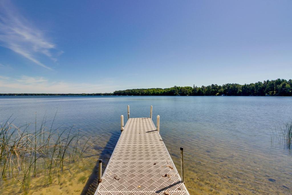 a dock in the middle of a large lake at Lakefront Minnesota Escape with Fire Pit and Boat Dock in Emily