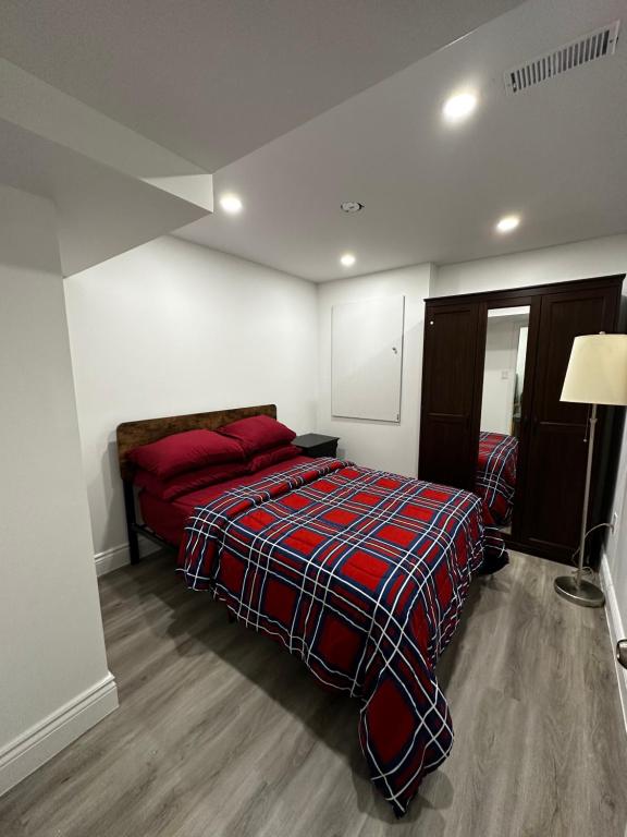 a bedroom with a bed with a plaid blanket at Tranquil Haven Retreat in Oakville