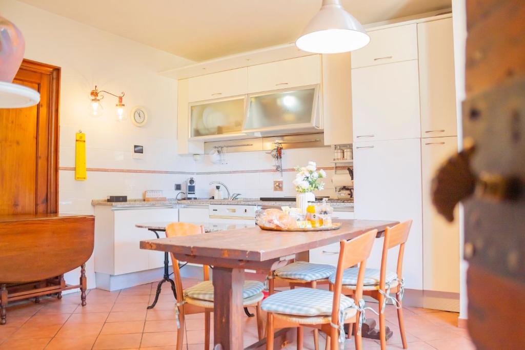 Una cocina con una mesa y sillas de madera. en Machiavelli Superior House, en Florencia