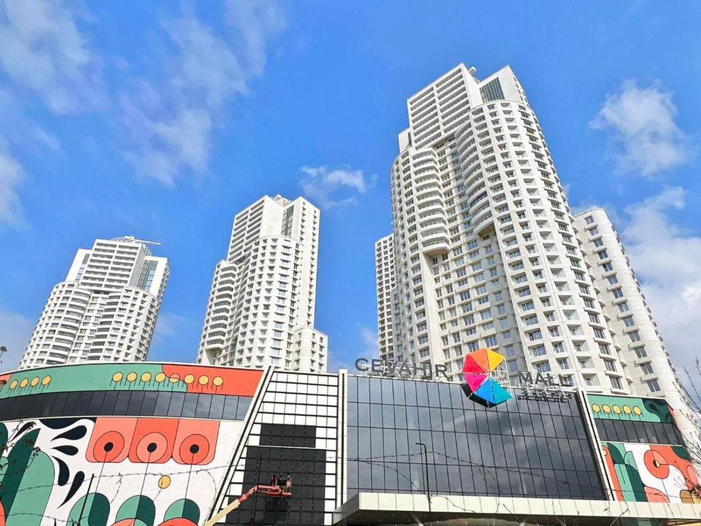 a building with a colorful umbrella in front of tall buildings at 37th Floor - SkyView Oasis - C in Skopje
