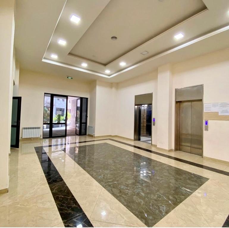 a large hall with a lobby with glass doors at Modern Stylish 1 bedroom Apartment by Republic Square, Middle of City CENTER in Yerevan