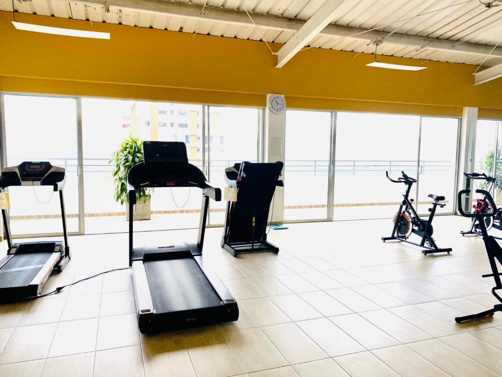 a gym with bikes and exercise equipment in a room at Luxury apartment in Armenia