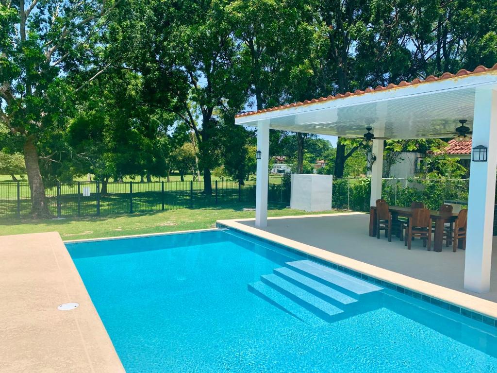 a swimming pool with a pergola next to a house at Sublime Villa in the Heart of Playa Coronado in Playa Coronado