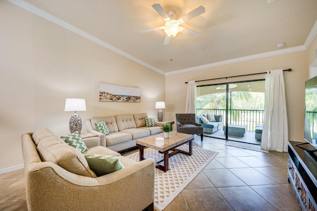 a living room with a couch and a table at Bonita Springs Condo Rental with 2 Screened Porches in Bonita Springs