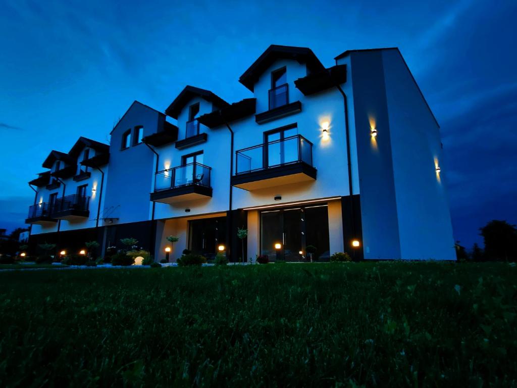 a large white building at night at DoriSol in Solec-Zdrój