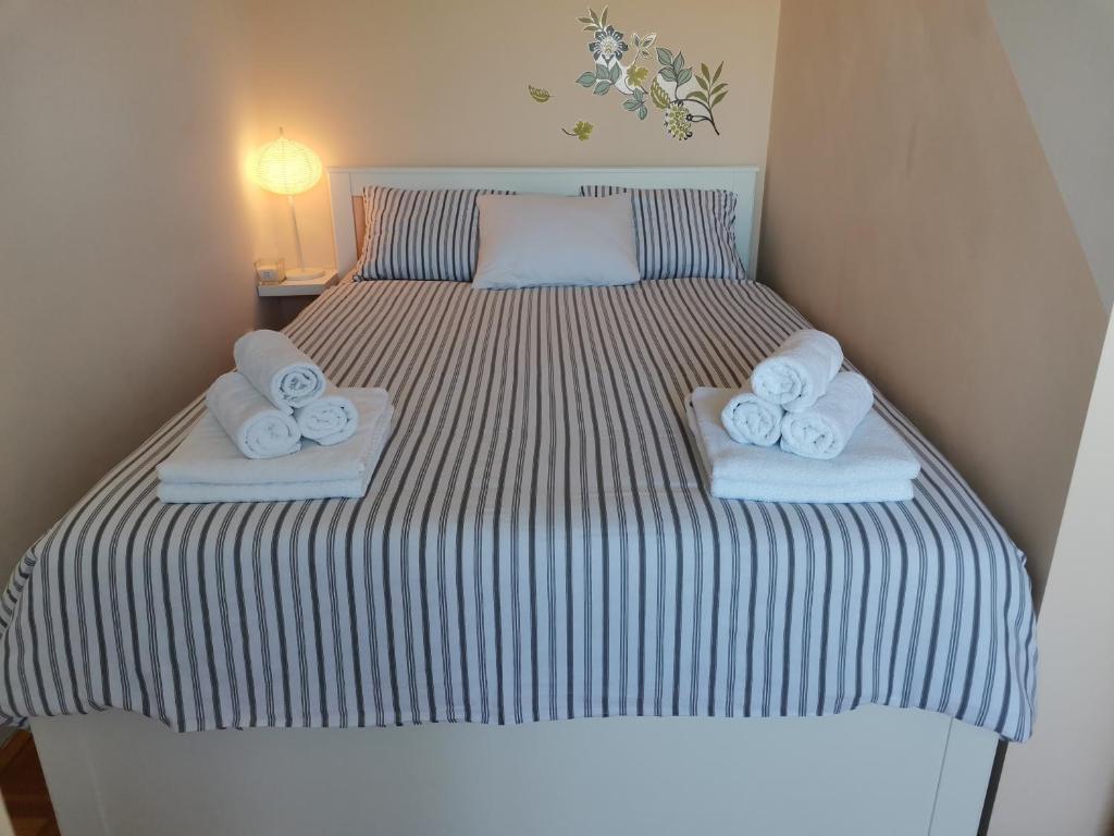 a bedroom with a bed with towels on it at Apartment Sky in Solin