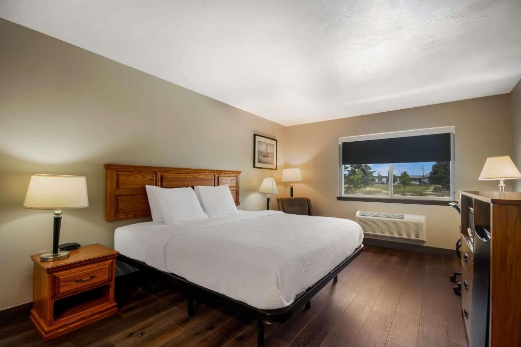 a bedroom with a large bed and a window at SureStay Plus Hotel by Best Western Rexburg in Rexburg