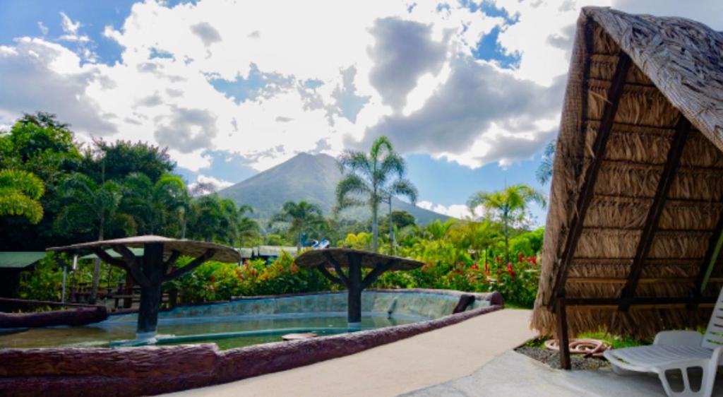 a resort pool with a view of a mountain at Termales del Arenal in Fortuna