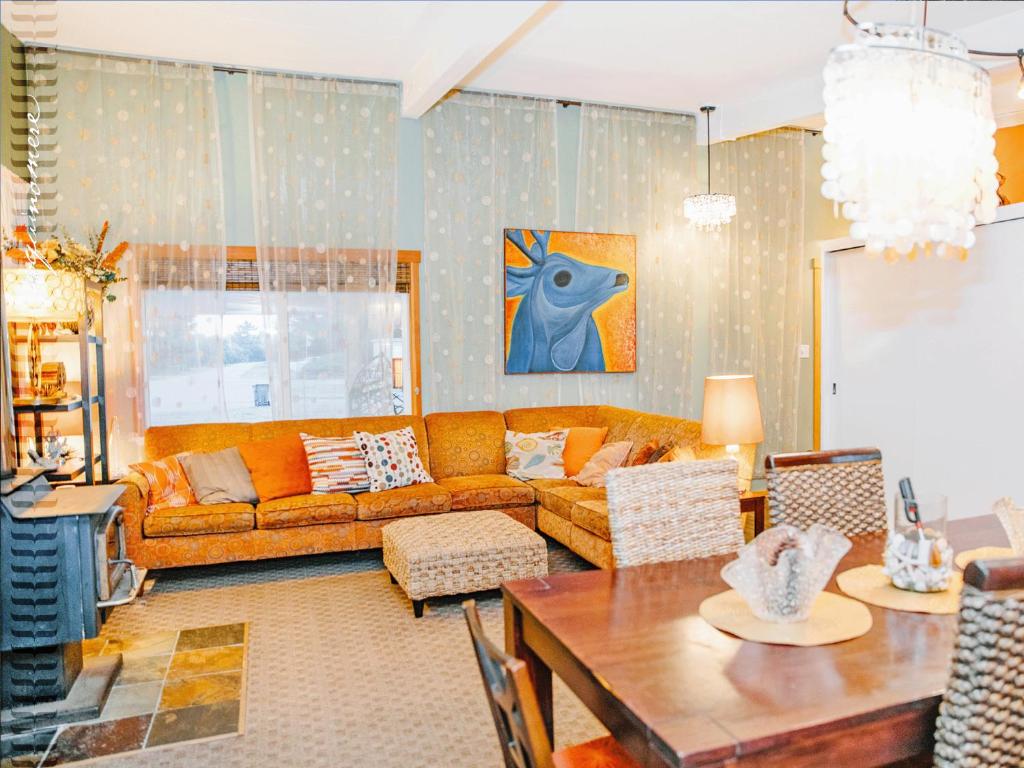 a living room with a couch and a table at Tide Pool Cabin, a Soquinomere Private Hotel on the Dunes, Downtown Ocean Shores in Ocean Shores