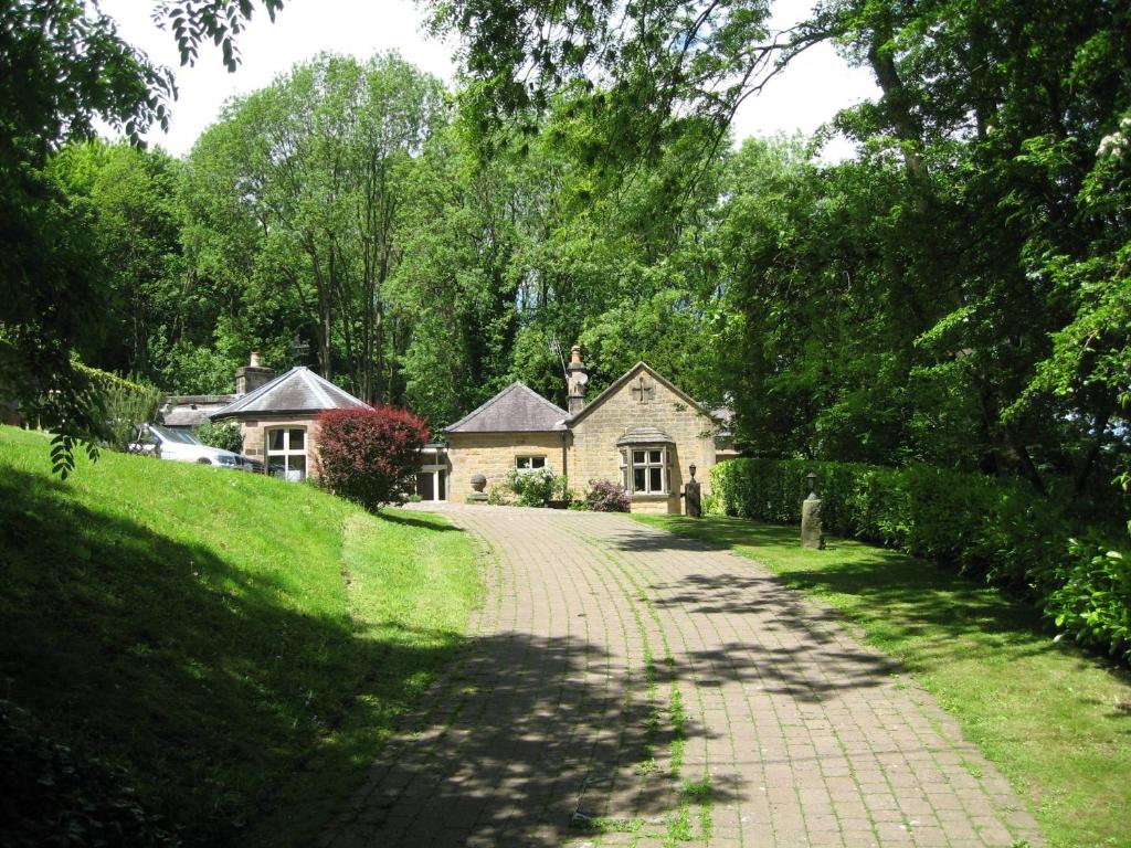 a brick road leading to a house in a park at Gardeners Cottage B and B in Bakewell