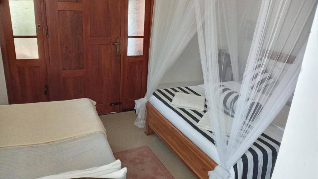 Postel nebo postele na pokoji v ubytování Ritz inn Ella
