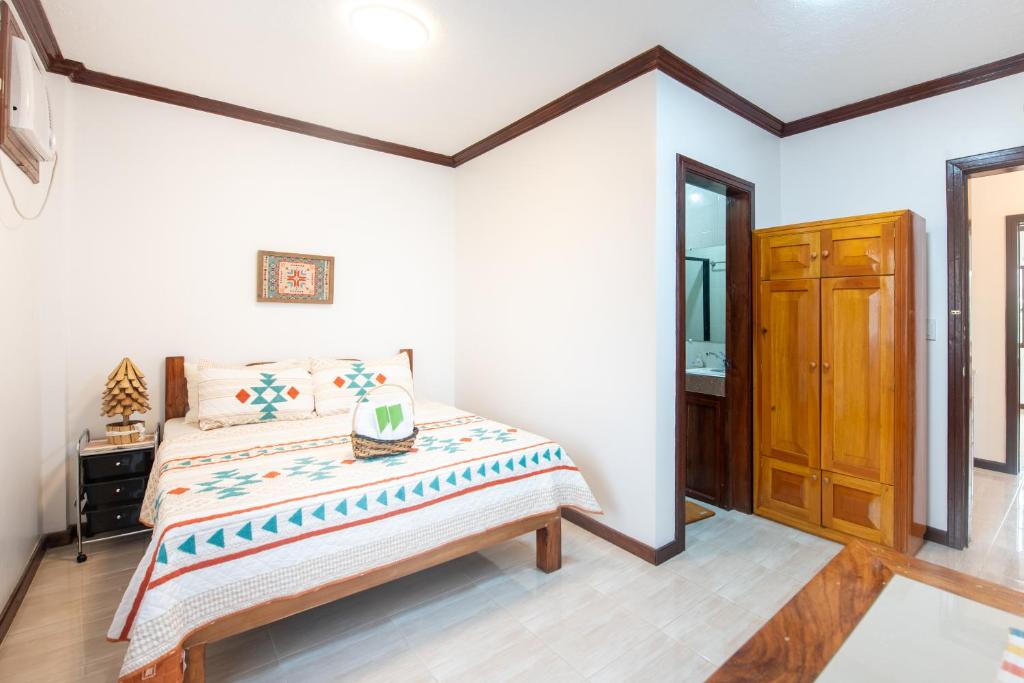 ein Schlafzimmer mit einem Bett in einem Zimmer in der Unterkunft Siesta Siargao in General Luna