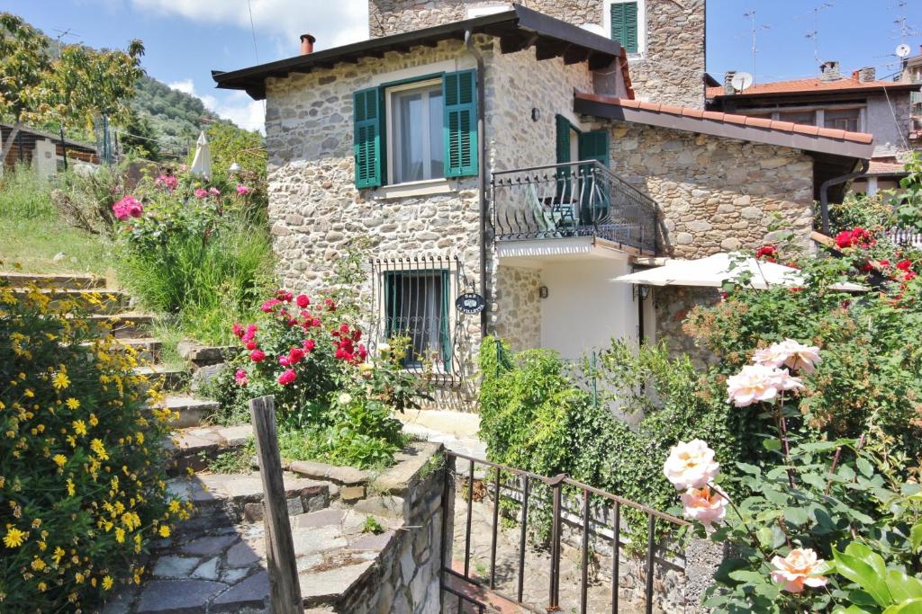 a stone house with flowers in front of it at B&B La Villetta in Dolceacqua