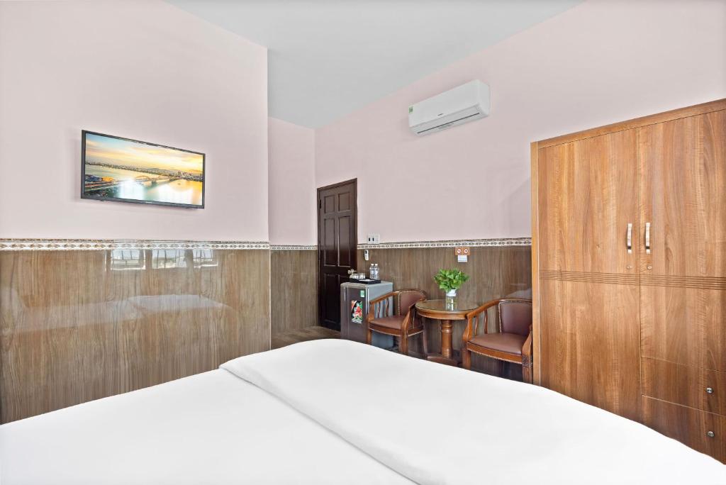 Postel nebo postele na pokoji v ubytování Mộc Nhiên Hotel Da Nang