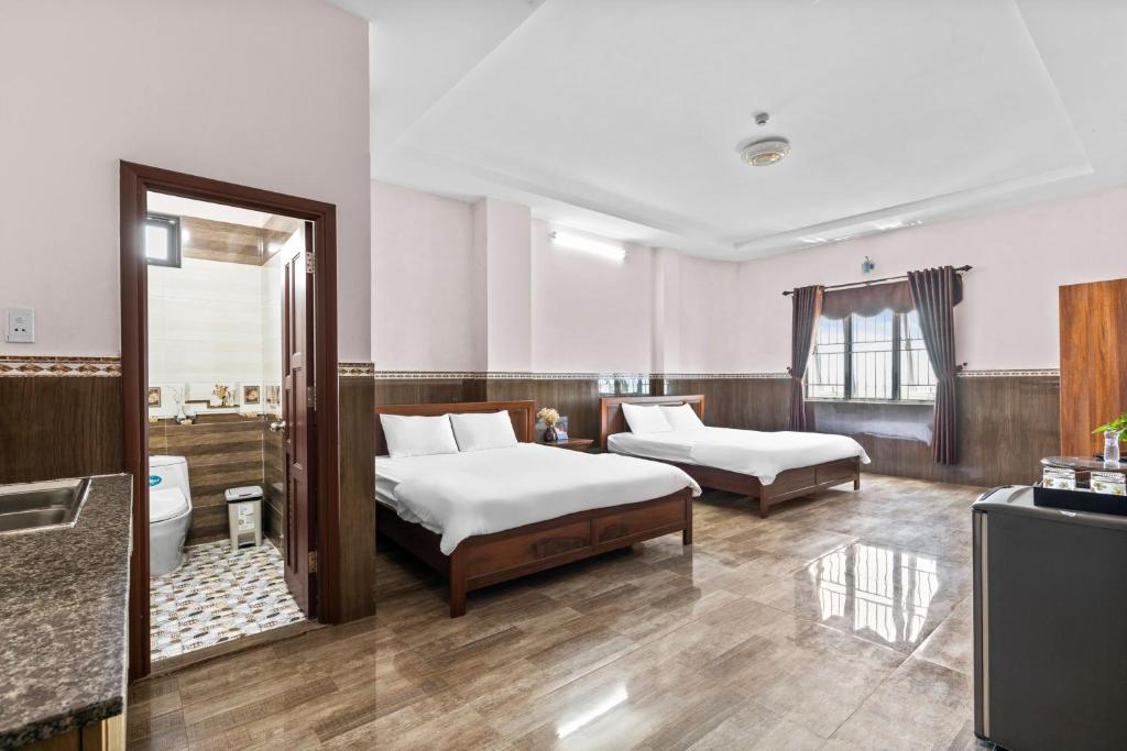Postel nebo postele na pokoji v ubytování Mộc Nhiên Hotel Da Nang