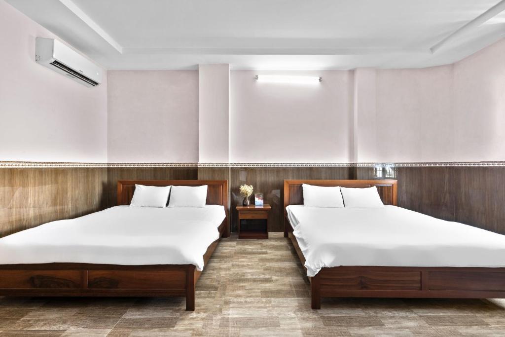 Postel nebo postele na pokoji v ubytování Mộc Nhiên Hotel Da Nang