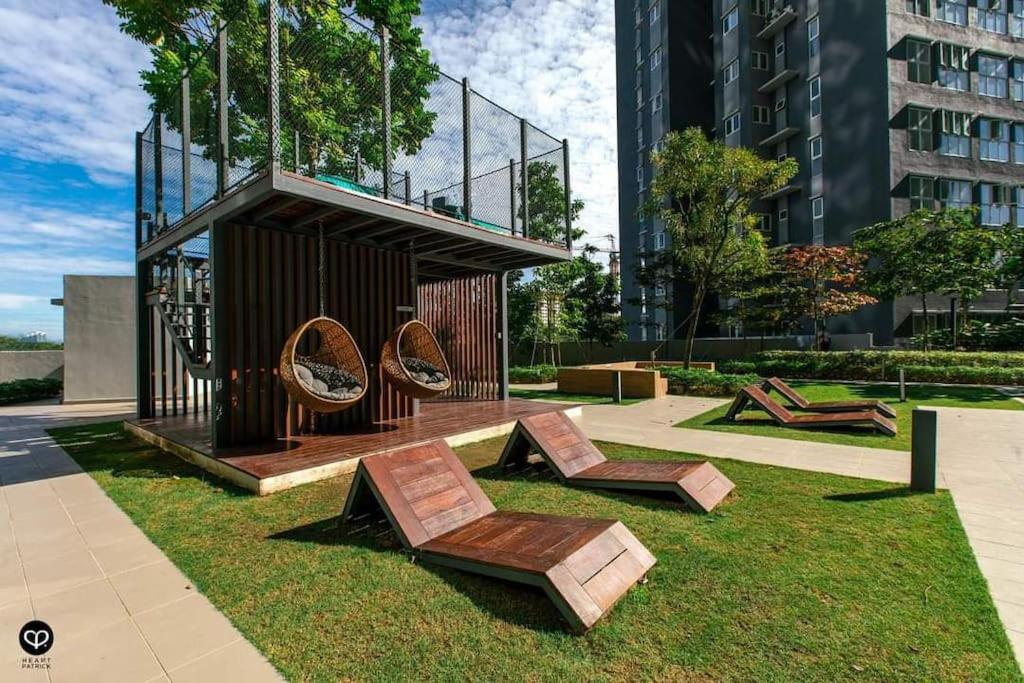a sculpture with two chairs on the grass at Selesa Homestay Canopy Hills Kajang in Hulu Langat