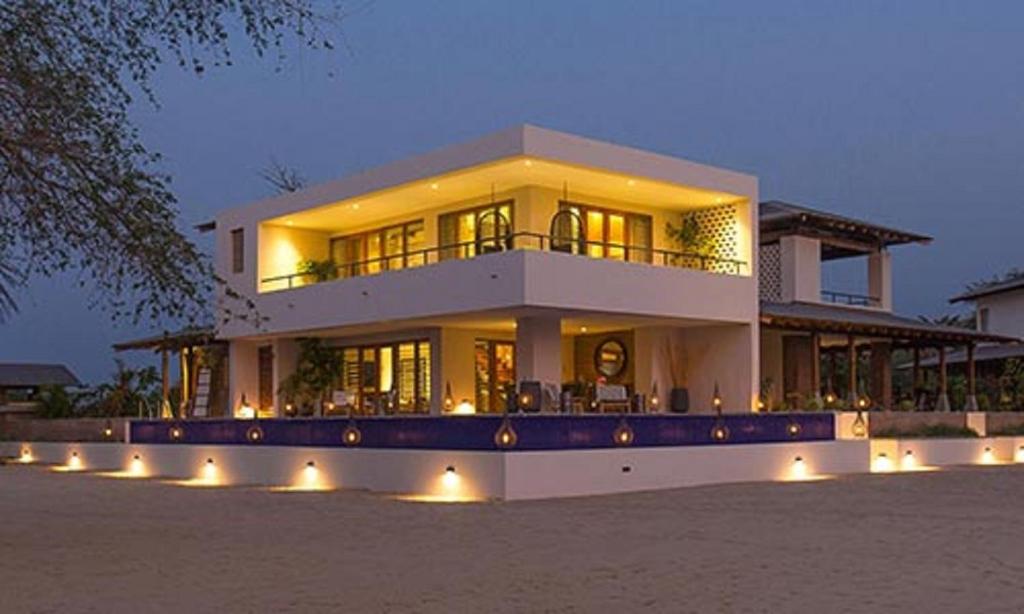a large house with lights in front of it at The Makokola Retreat in Mponda