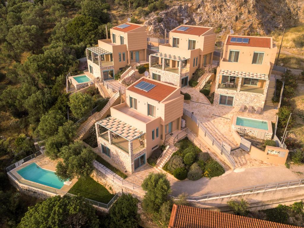 an aerial view of a mansion with a swimming pool at Ouzo Panoramic Houses 1, with private pool in Plomarion