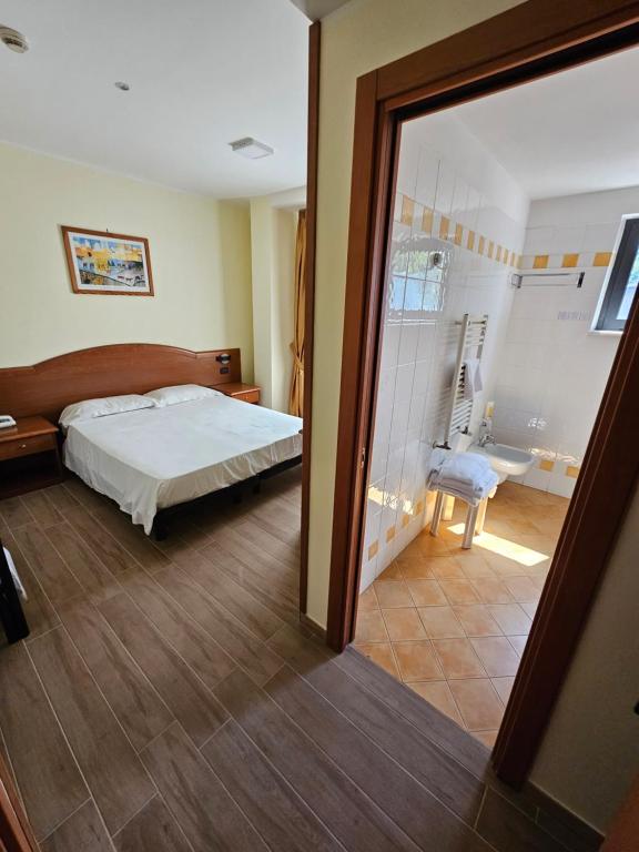 Postel nebo postele na pokoji v ubytování Hotel Dimora Adriana