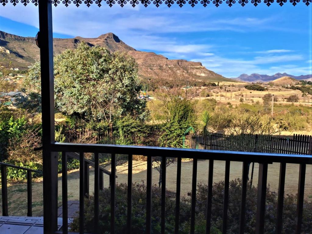 a view from a balcony with mountains in the background at Mystic Mountain Cottage in Clarens