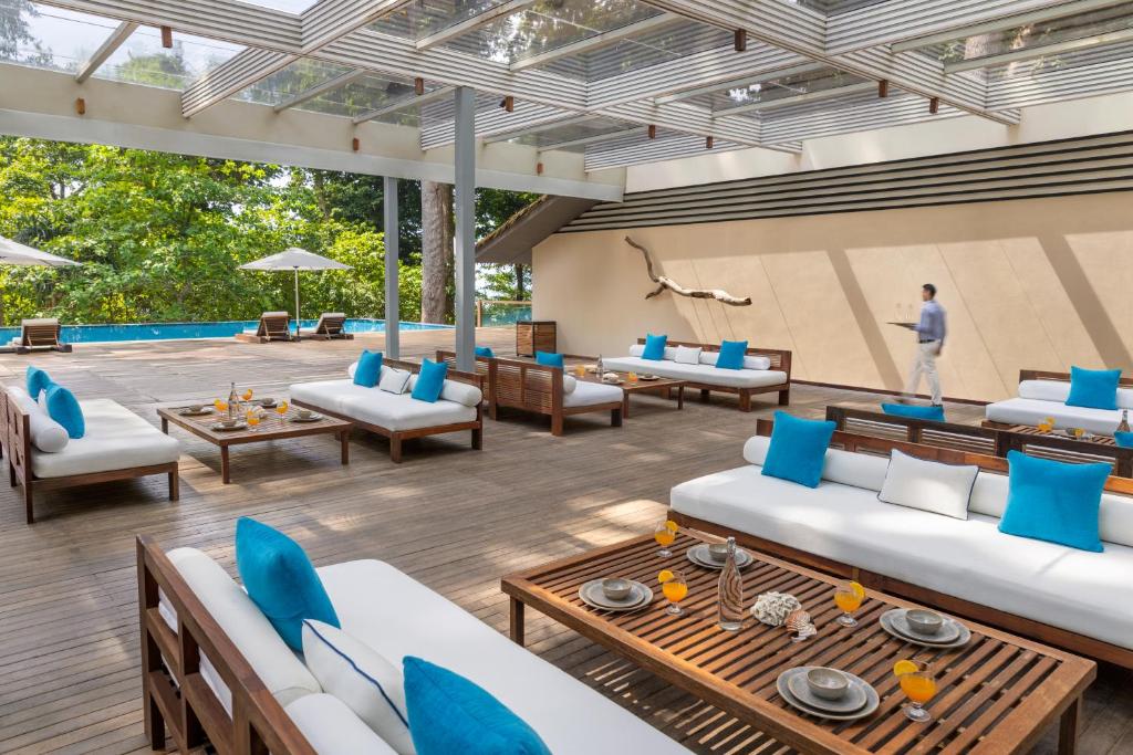 a living room with blue and white furniture and a pool at Taj Exotica Resort & Spa, Andamans in Havelock Island