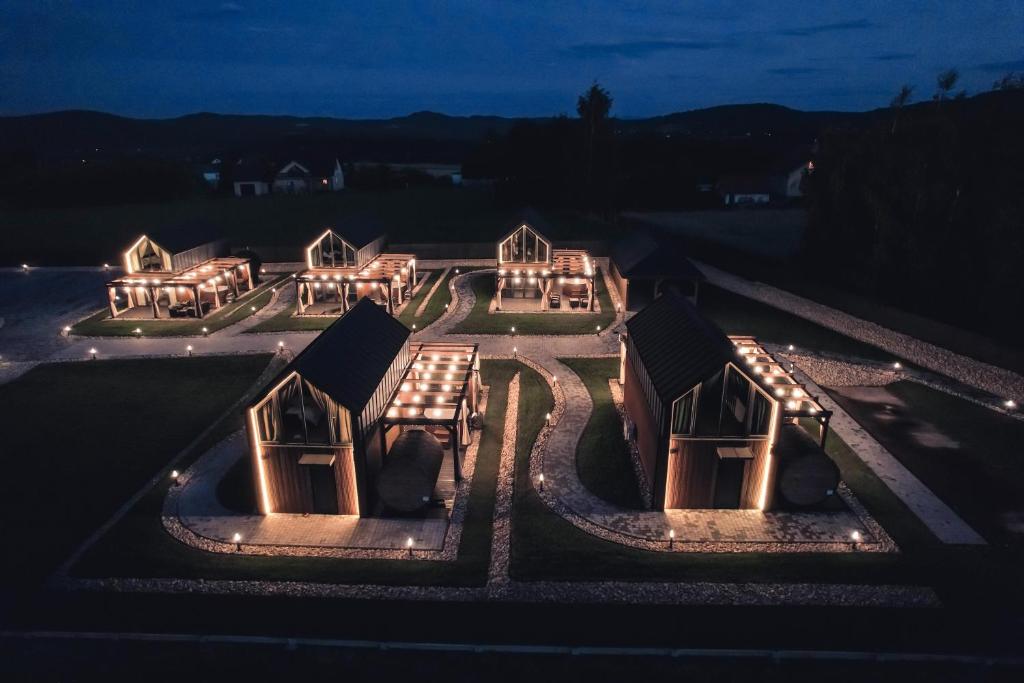 a group of houses lit up at night at VILLAGE RESORT Sauna & Jacuzzi & Netflix in Tworkowa