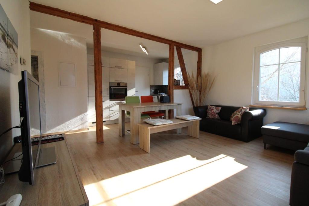 a living room with a couch and a table at Schwarzwaldblick in Schramberg