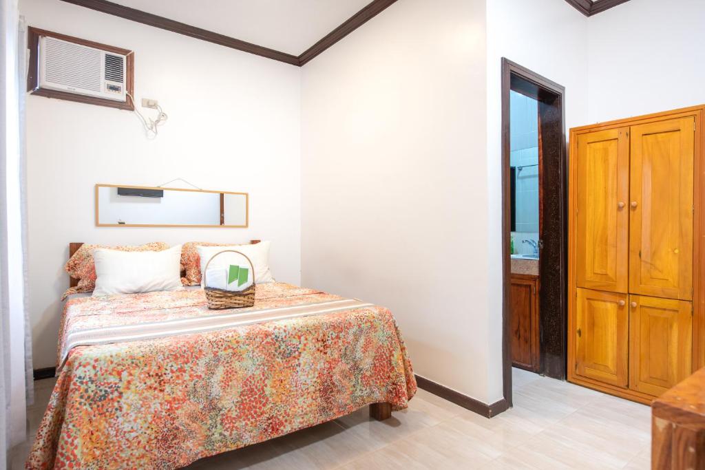 Postel nebo postele na pokoji v ubytování Siesta Siargao