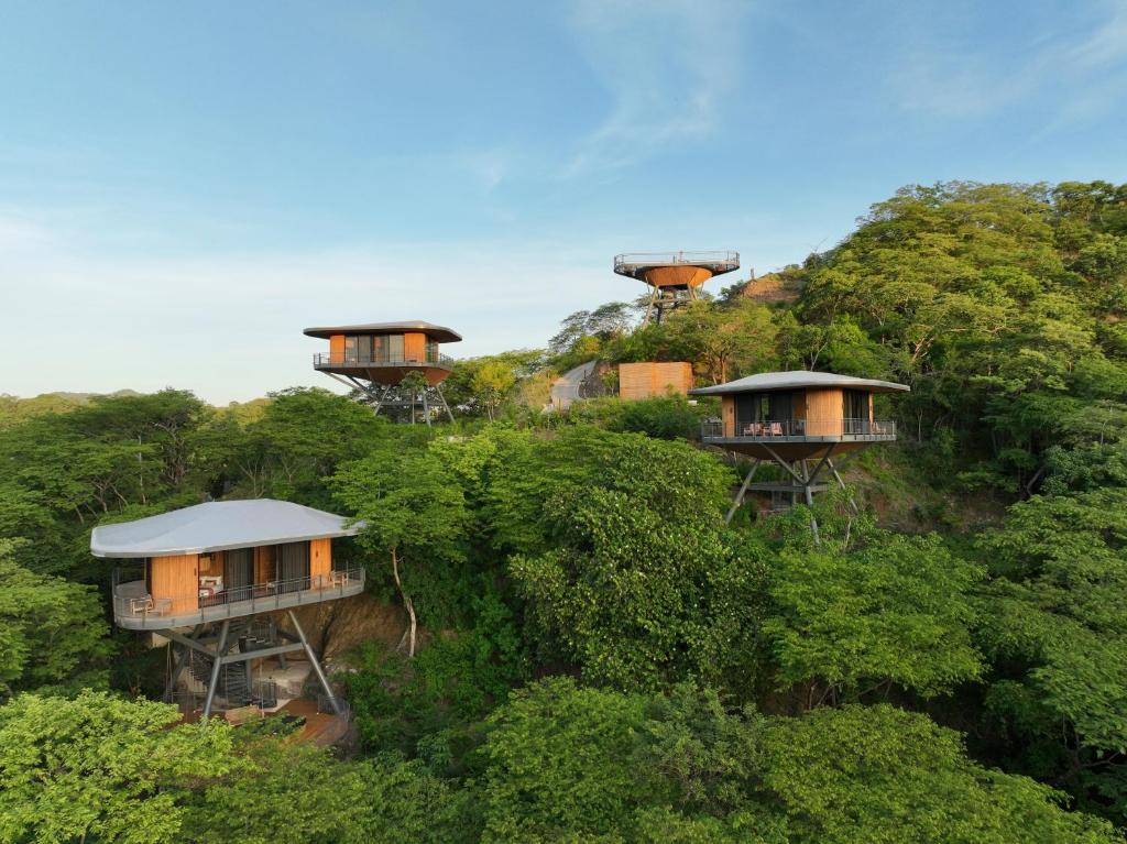 a group of houses on top of a hill at Suitree Experience Hotel in Guanacaste