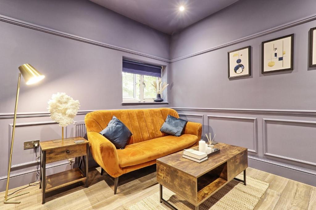 a living room with a yellow couch and a table at Opulent Abode - Stunning One-Bedroom Flat - Southend Stays in Southend-on-Sea