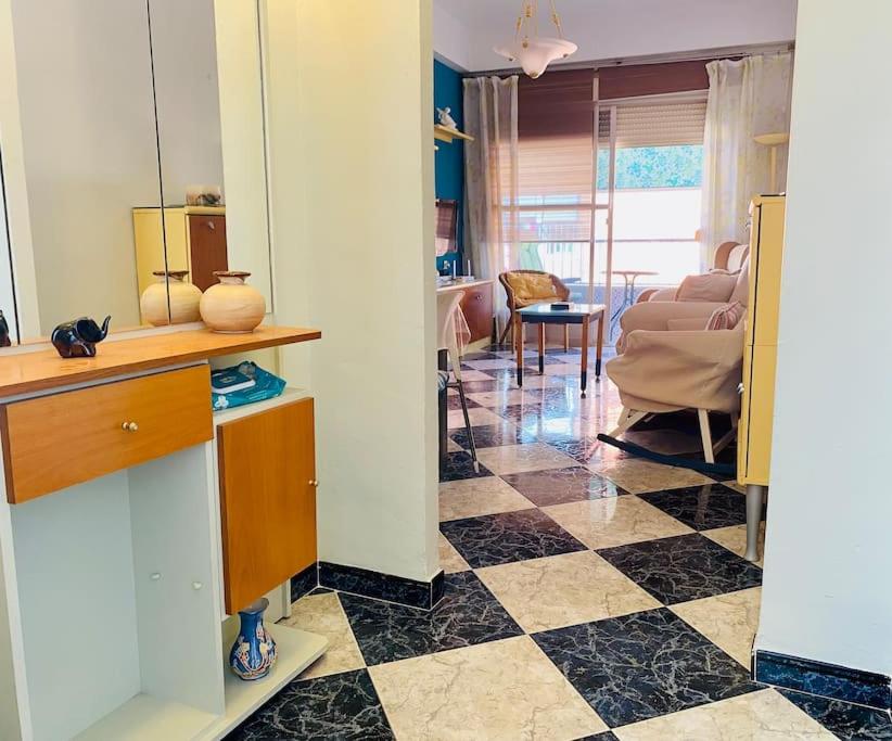 a living room with a checkered floor at Piso céntrico Torrenueva Costa in Torrenueva