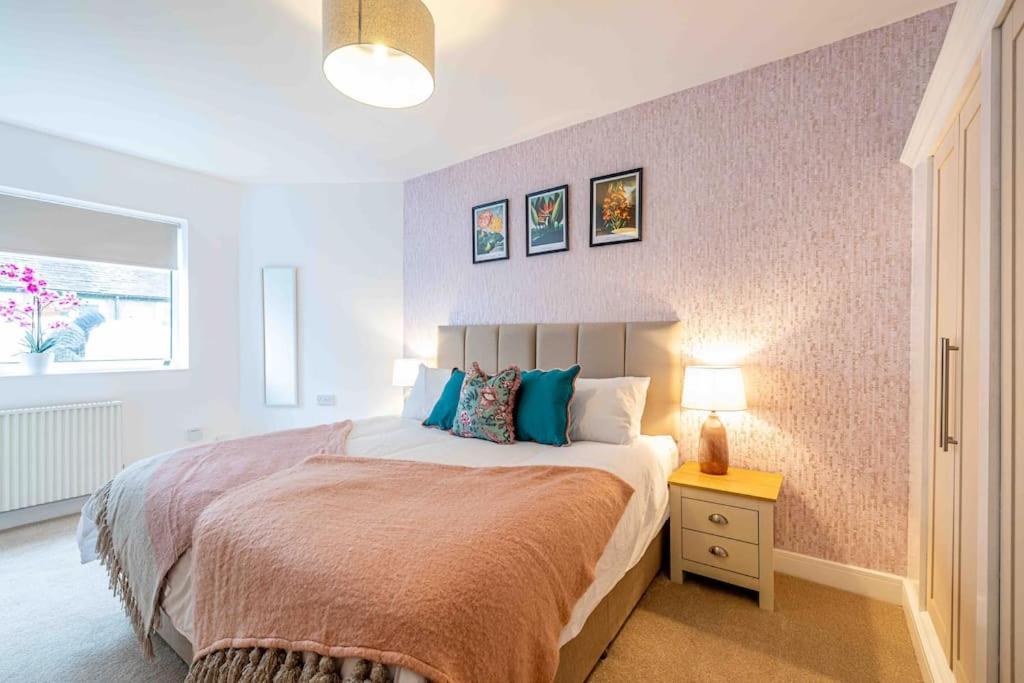 a bedroom with a bed and a table with a lamp at Something a little bit special! in Llandudno