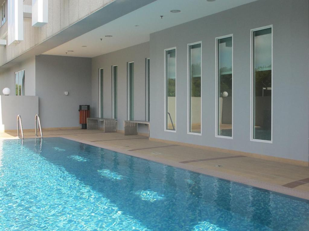a large swimming pool in a building with at Badi'ah Hotel in Bandar Seri Begawan
