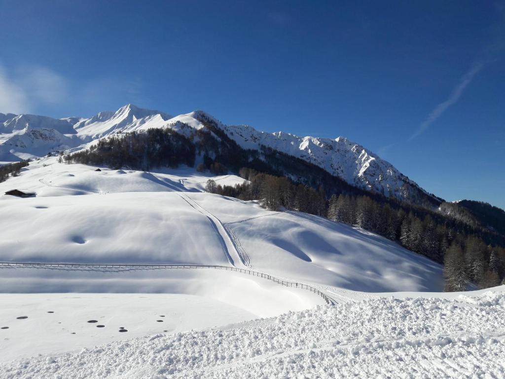 a snow covered slope with a mountain in the background at PLAGNE-SOLEIL Pied des pistes in La Plagne Tarentaise