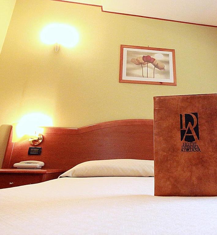 Postel nebo postele na pokoji v ubytování Hotel Dimora Adriana