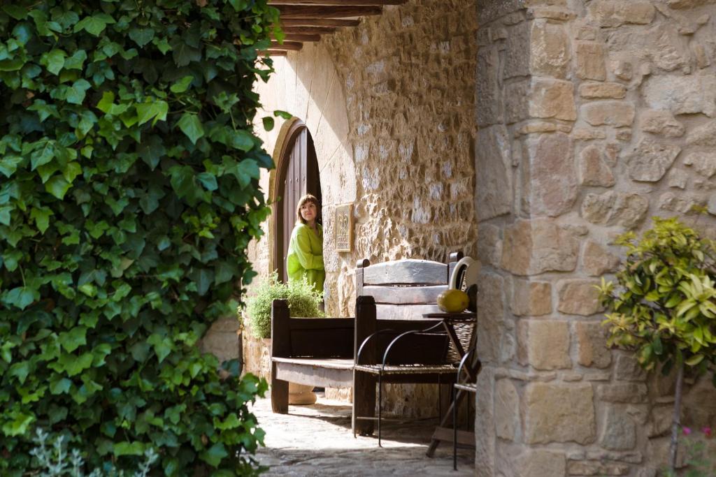 a woman standing in the doorway of a building at La Torre del Visco - Relais & Châteaux in Fuentespalda