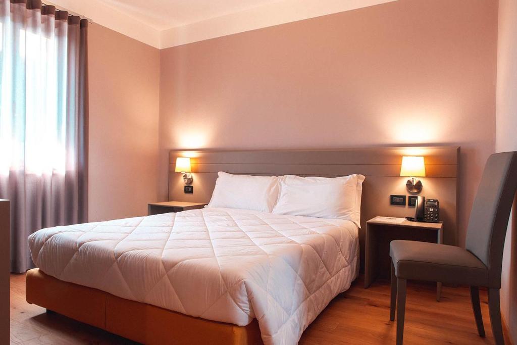 Postel nebo postele na pokoji v ubytování Hotel Patriarchi