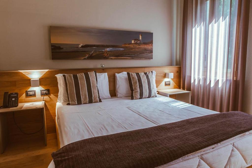 Postel nebo postele na pokoji v ubytování Hotel Patriarchi