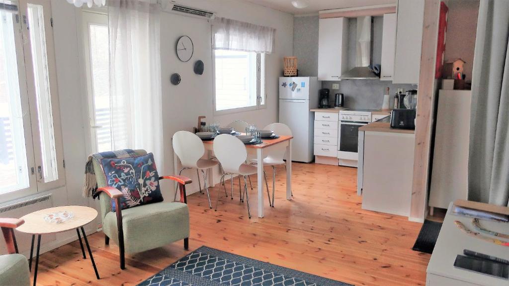 a kitchen with a table and chairs in a room at Saunallinen kaksio, asunto Kolin Kolo in Kolinkylä