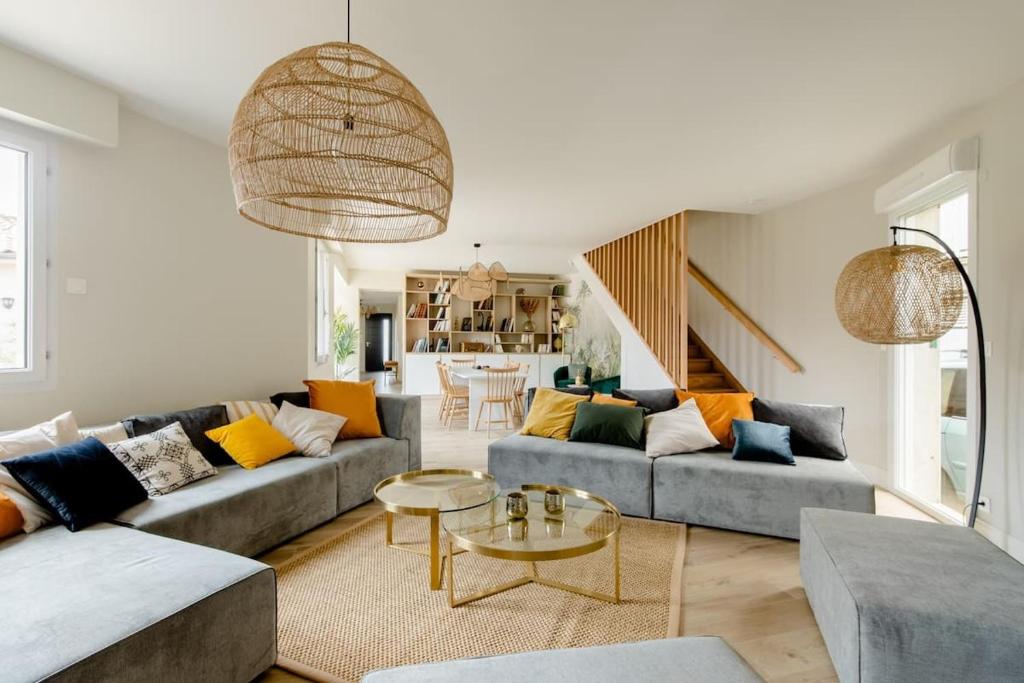 uma sala de estar com dois sofás e uma mesa em La Villa l'Escale, somptueuse maison contemporaine em Angoulême