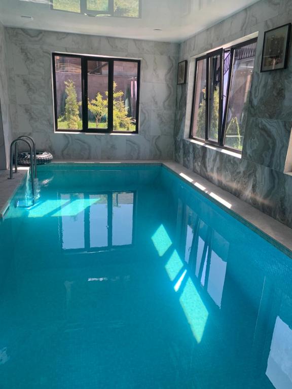 a swimming pool with blue water in a house at Harmony Resort in Tsaghkadzor