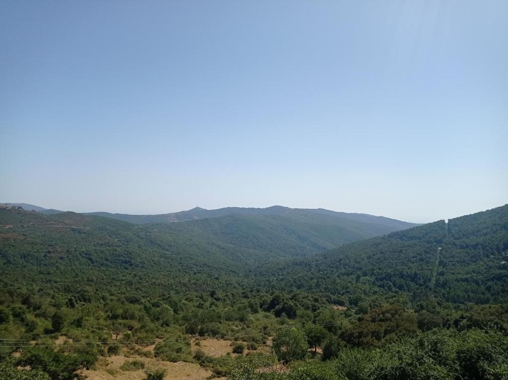 a view of a valley with mountains in the distance at Maison de village, charmante et authentique, haute-corse in Vezzani