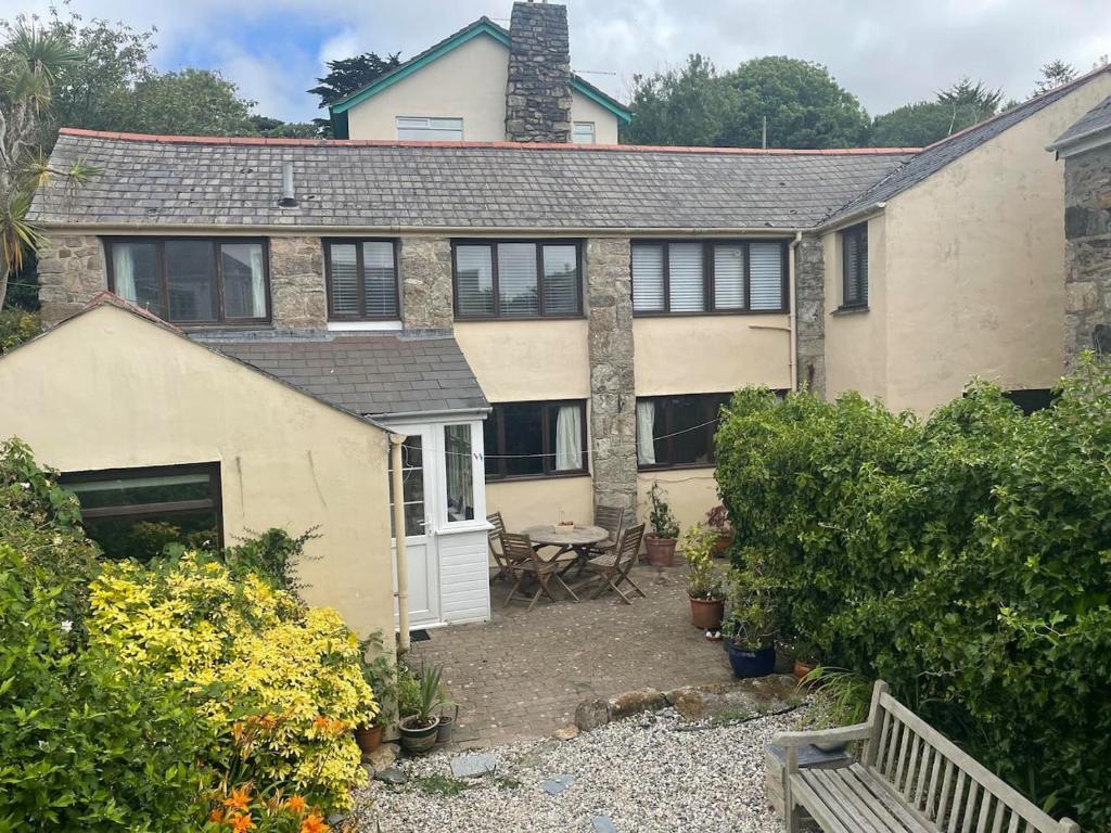 an exterior view of a house with a patio at The Old Barn in St Ives