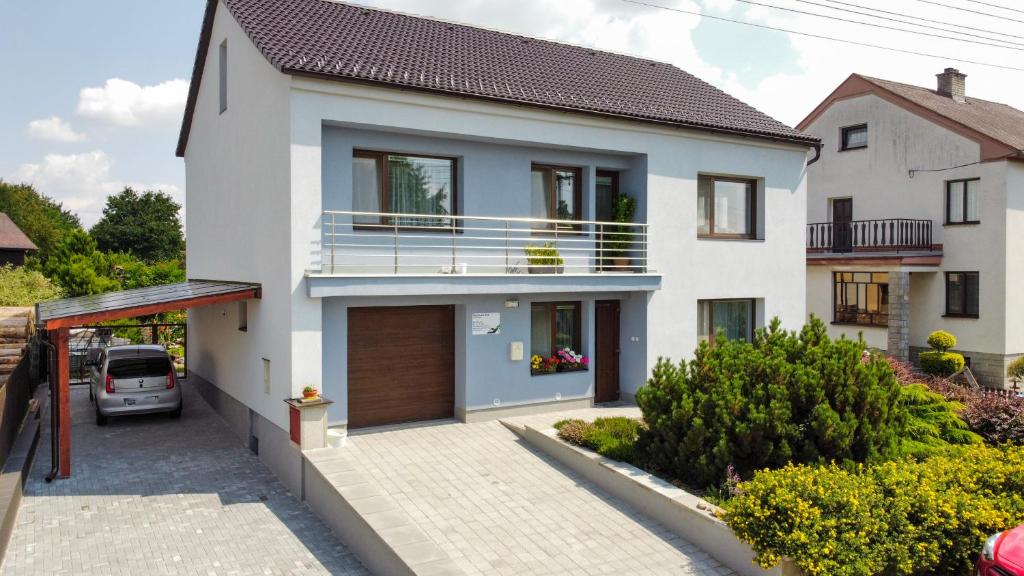 a white house with a balcony and a driveway at Ubytování EVA in Stará Říše
