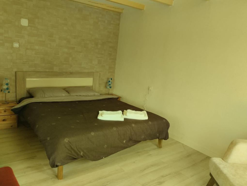 a bedroom with a bed with two towels on it at Villa Nënë Terezës in Pristina