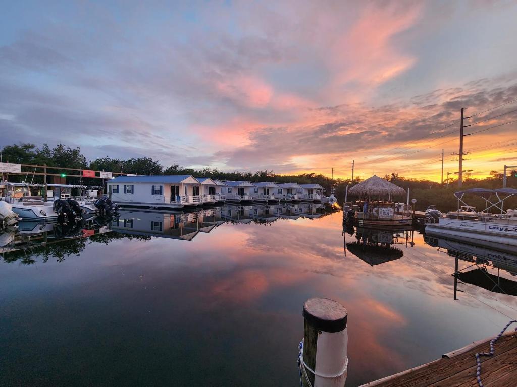 a view of a marina at sunset with houses at Aqua Lodges At Hurricane Hole Marina in Key West