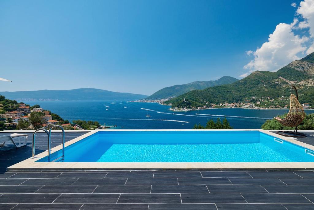 a swimming pool with a view of the ocean at Villa Bojana in Tivat